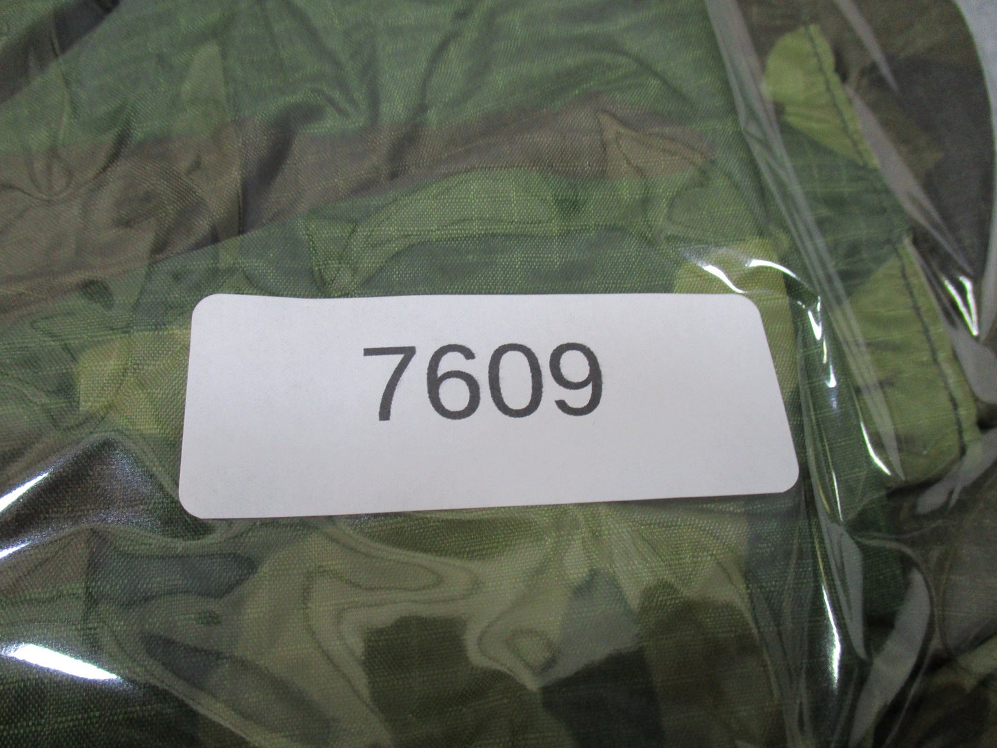 USGI military woodland rain poncho made of ripstop fabric by Centex Military Gear, designed for outdoor rain protection.