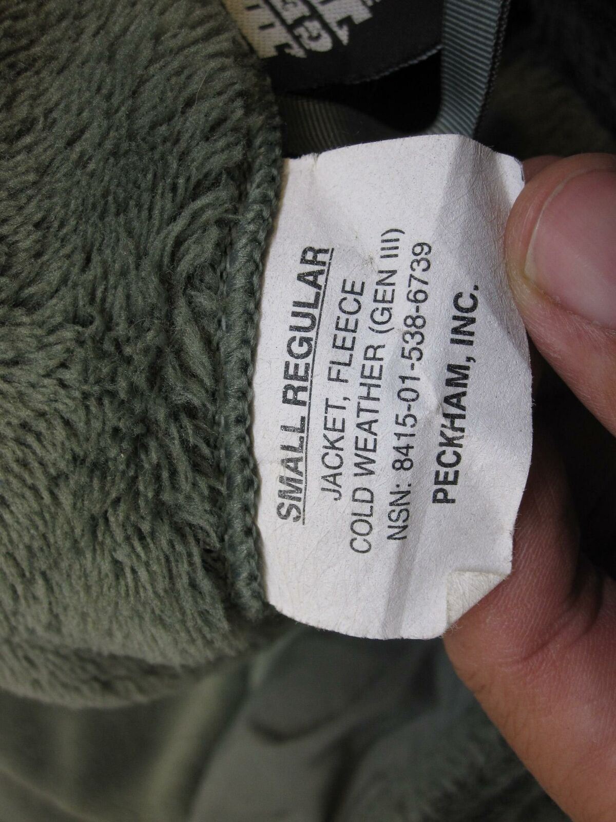 Used Polartec Gen III Army fleece jacket in foliage green, military cold weather top with ACU UCP camouflage pattern.