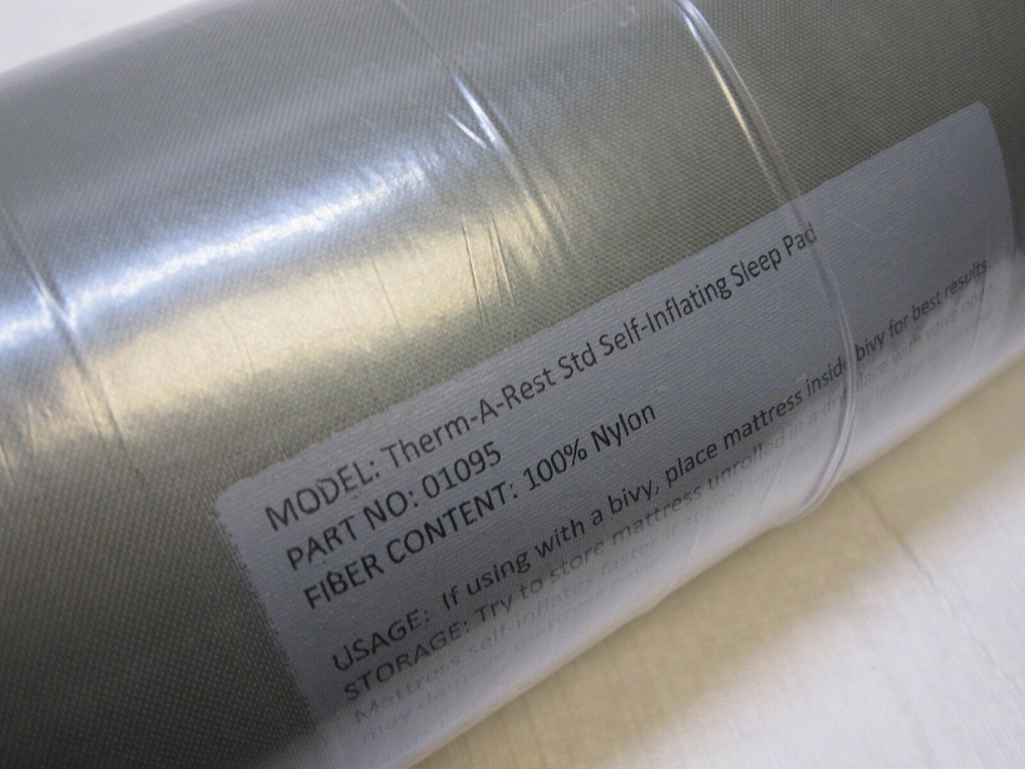 Military Therm-A-Rest self-inflating sleeping pad in foliage camouflage, designed for outdoor camping and army use.