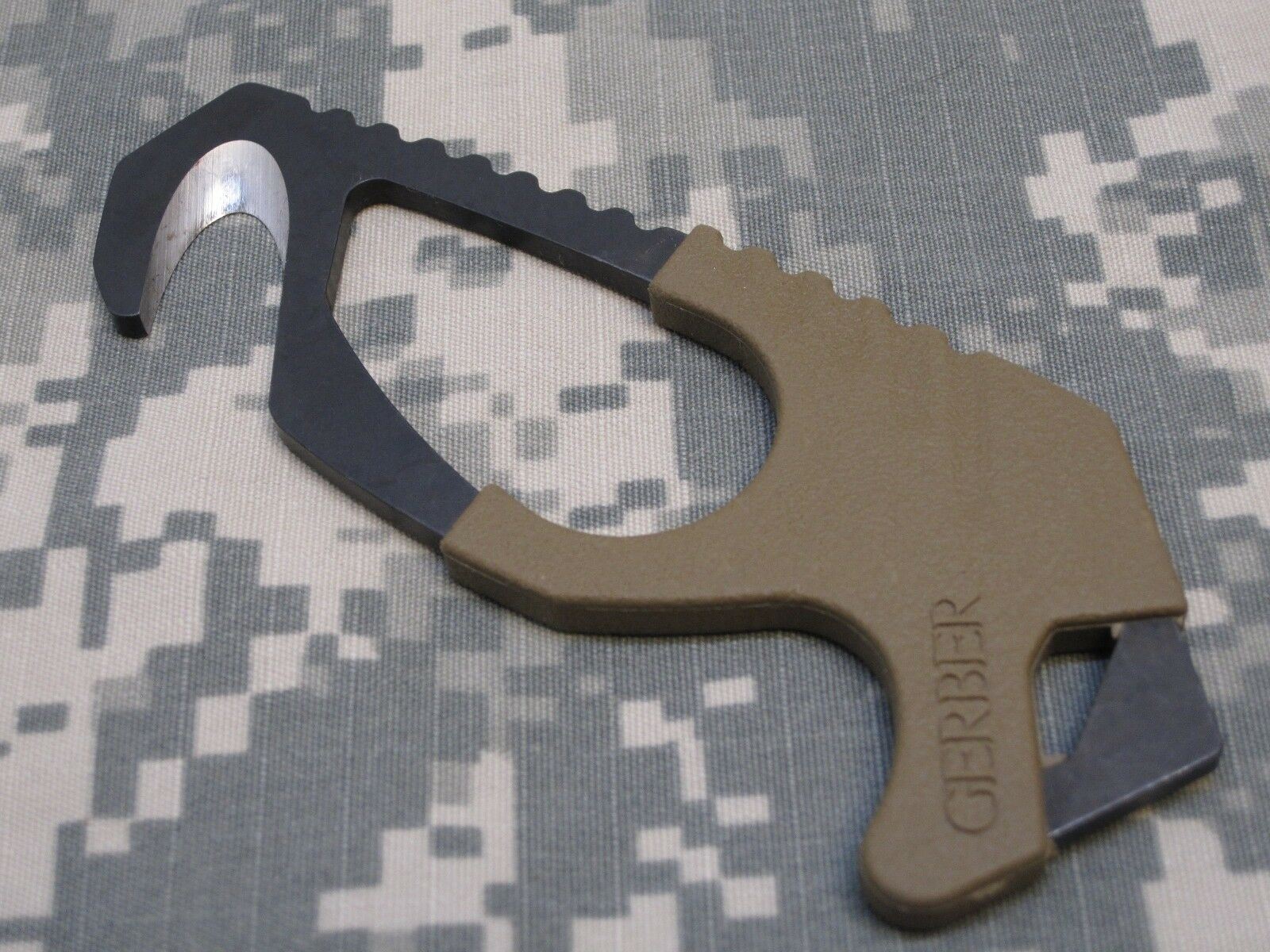 US military issue Gerber coyote brown strap cutter and seat belt hook knife with Army OCP camouflage pattern, by Centex Military Gear.