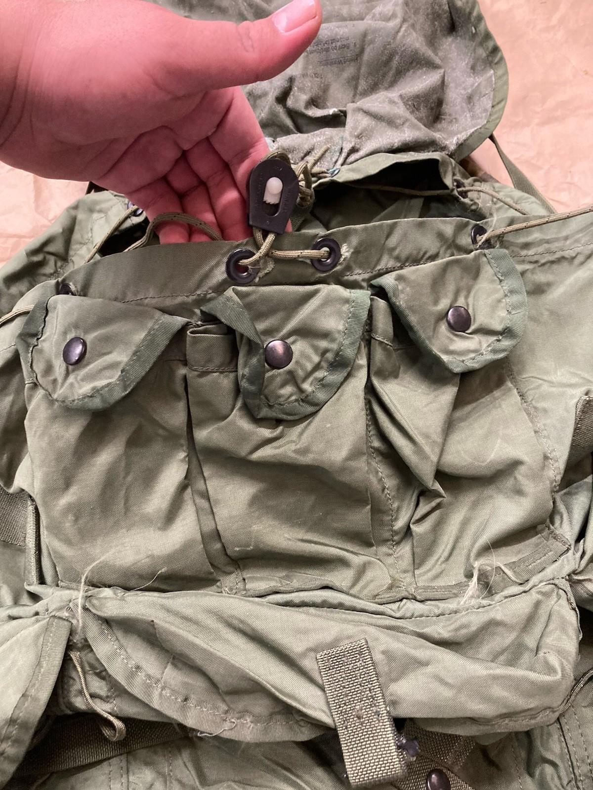 USGI Large Ruck Alice Pack in olive green, showcasing adjustable straps and multiple compartments for military use.