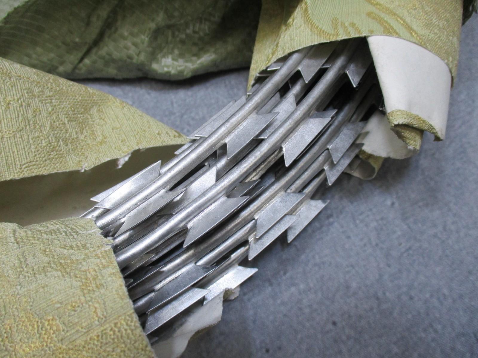 Vintage USGI military concertina barbed wire coil, 24-inch NOS perimeter security wire with sharp barbs, by Centex Military Gear.