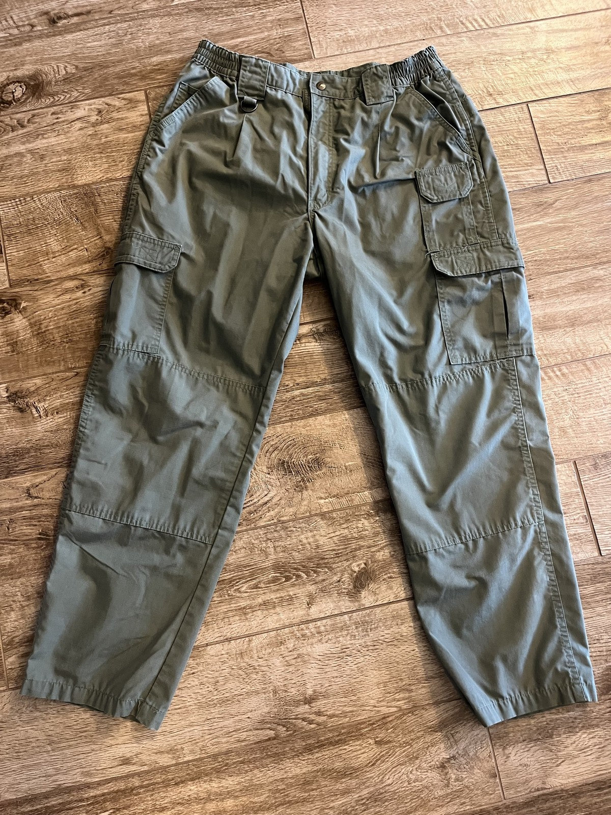 Men's Propper tactical cargo pants in olive drab ripstop fabric, size 36/34, featuring multiple pockets and durable military-style design.