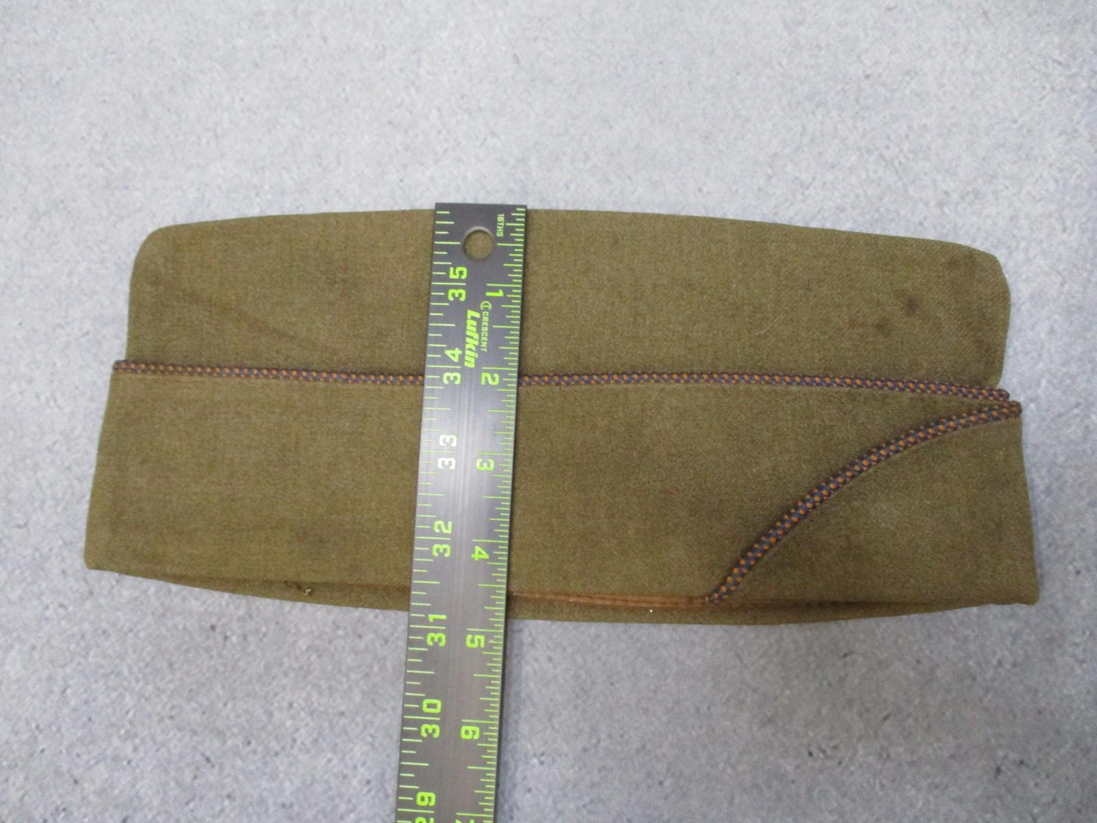 WWII USAAF Garrison Cap with Technical Training Command DUI patch, worn by military personnel, featuring a black fabric design.