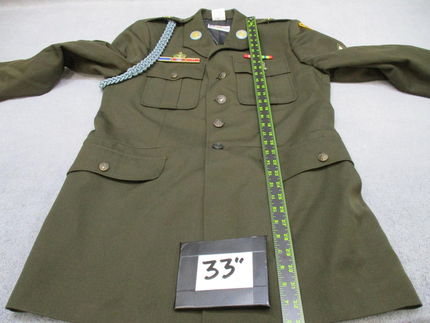 US Army AGSU service dress coat in heritage green with ribbons, military jacket with brass buttons, tailored fit, and shoulder epaulets.