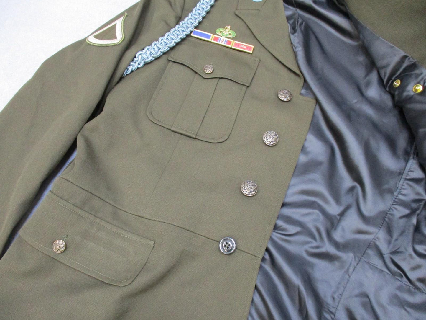 US Army AGSU service dress coat jacket in heritage green with ribbons, displayed on a hanger, by Centex Military Gear.