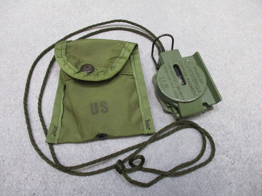 Cammenga 3H magnetic compass with phosphorescent dial, US military issue, in durable pouch, used for navigation and orienteering.