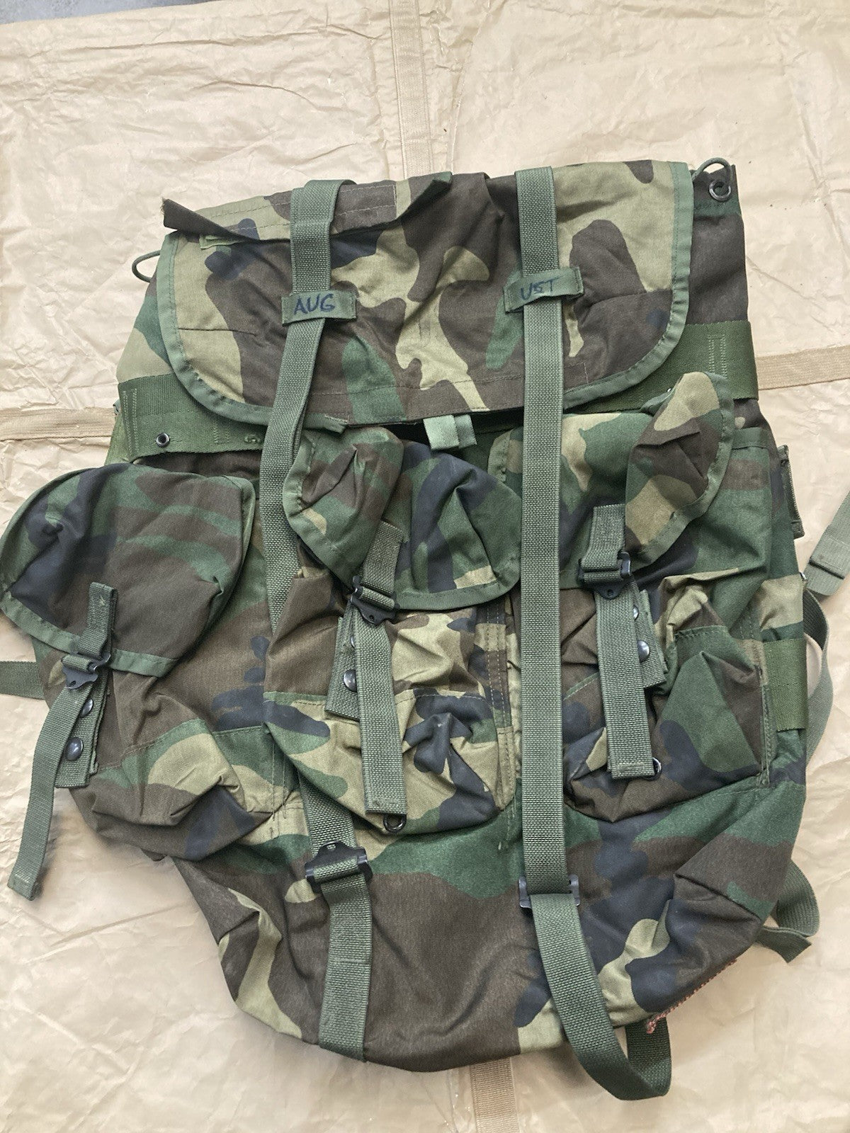 Centex Military Gear Alice Pack M81 Woodland tactical bag with writing, featuring multiple compartments and adjustable straps.