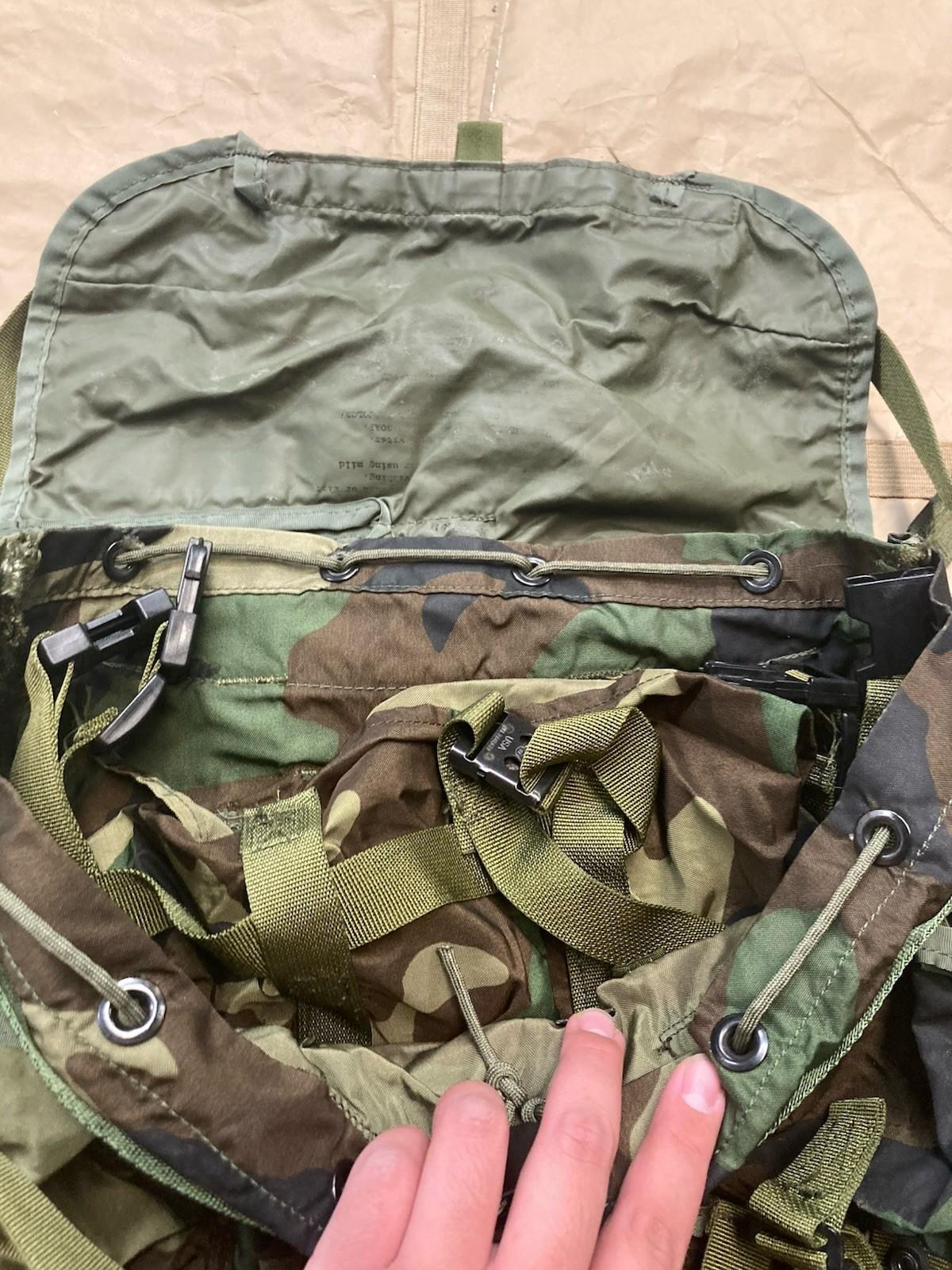 Centex Military Gear woodland camo radio carrying case inside M81 tactical backpack with multiple compartments and adjustable straps.