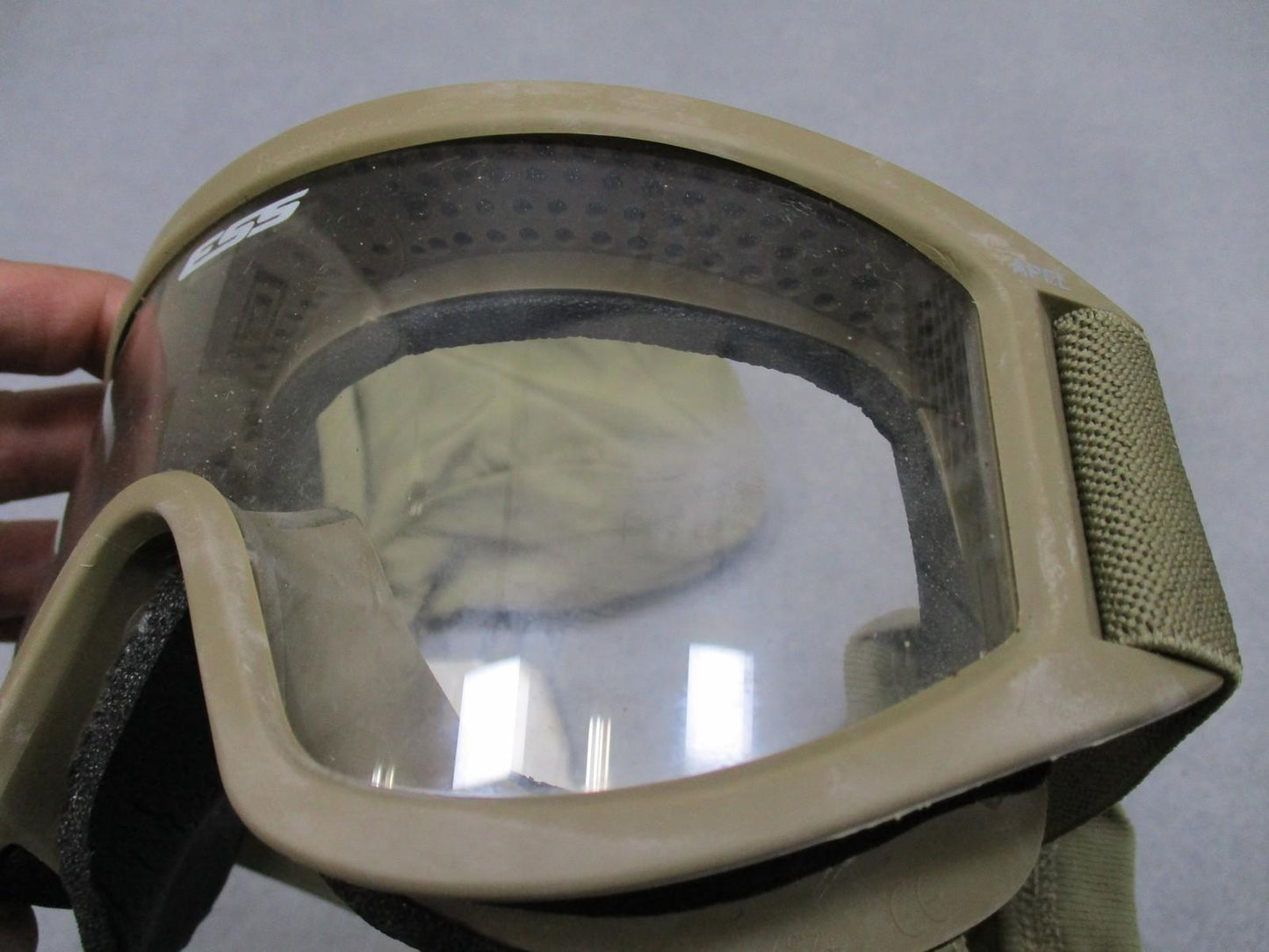 Used USGI ESS APEL ballistic goggles with tinted lens and pouch, designed for military protection and eye safety.