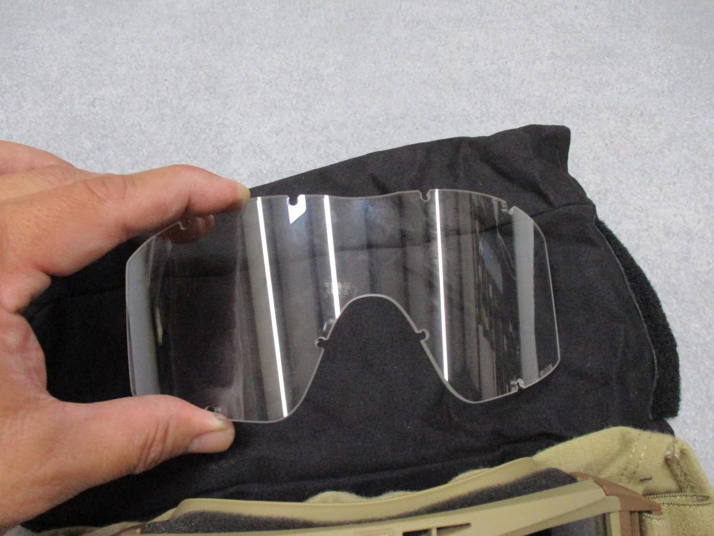 Used Revision Military Desert Locust goggles with clear lenses and pouch, designed for military or tactical use.