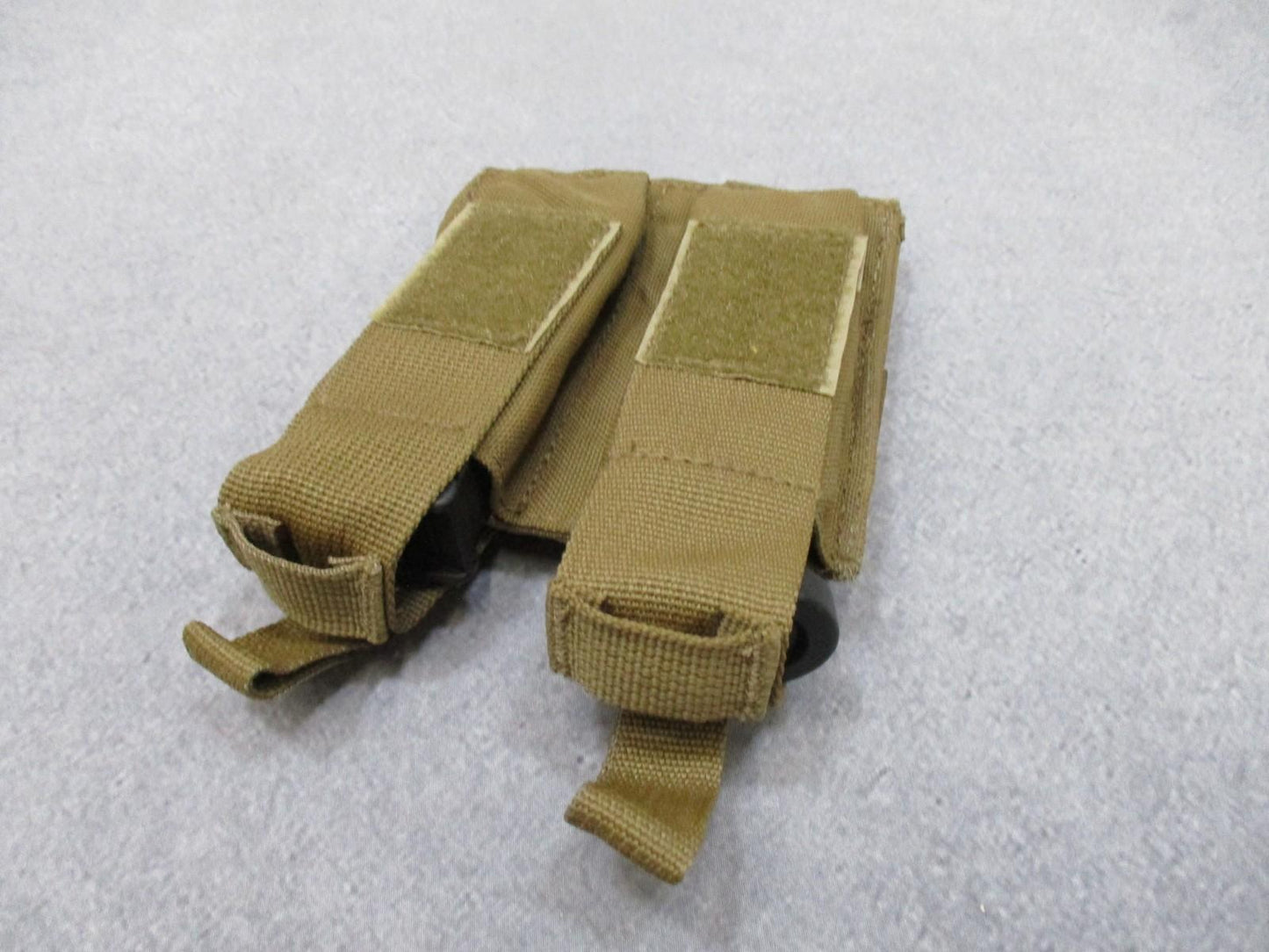 Used AWS Inc. double pistol magazine pouch with MOLLE attachment in coyote color, made in USA, by Centex Military Gear.