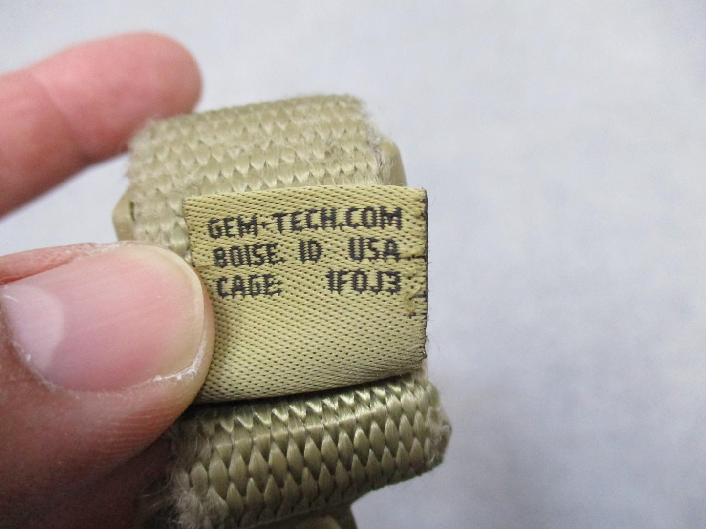 Tan Gem-Tech pistol lanyard dummy cord from Centex Military Gear with coiled design for tactical duty use.