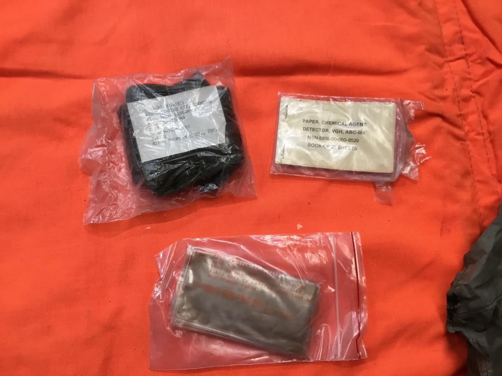 Small size Usgi Gas Mask M25a1 pilot aviator surplus mask with adjustable straps, black rubber facepiece, and clear eye lenses.