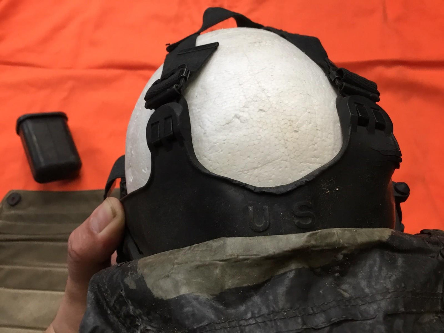Damaged M17 gas mask from Centex Military Gear collection, size medium, displayed with visible cracks and wear.