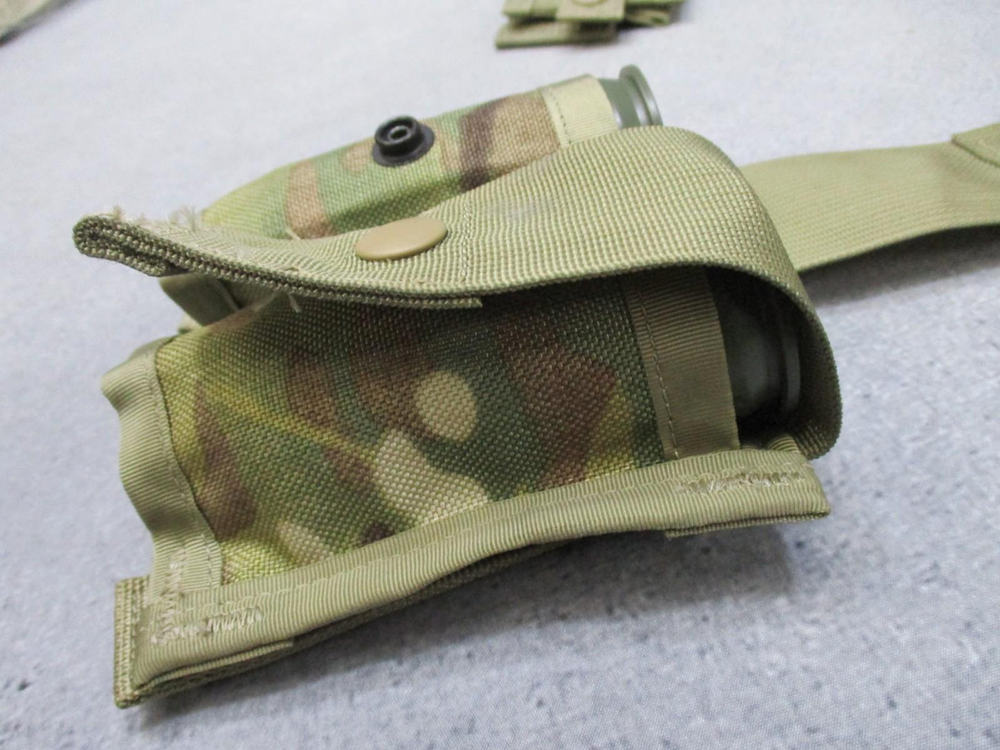 USGI MOLLE II 40mm grenade pouch set in Multicam with one double and two single pouches for military gear.