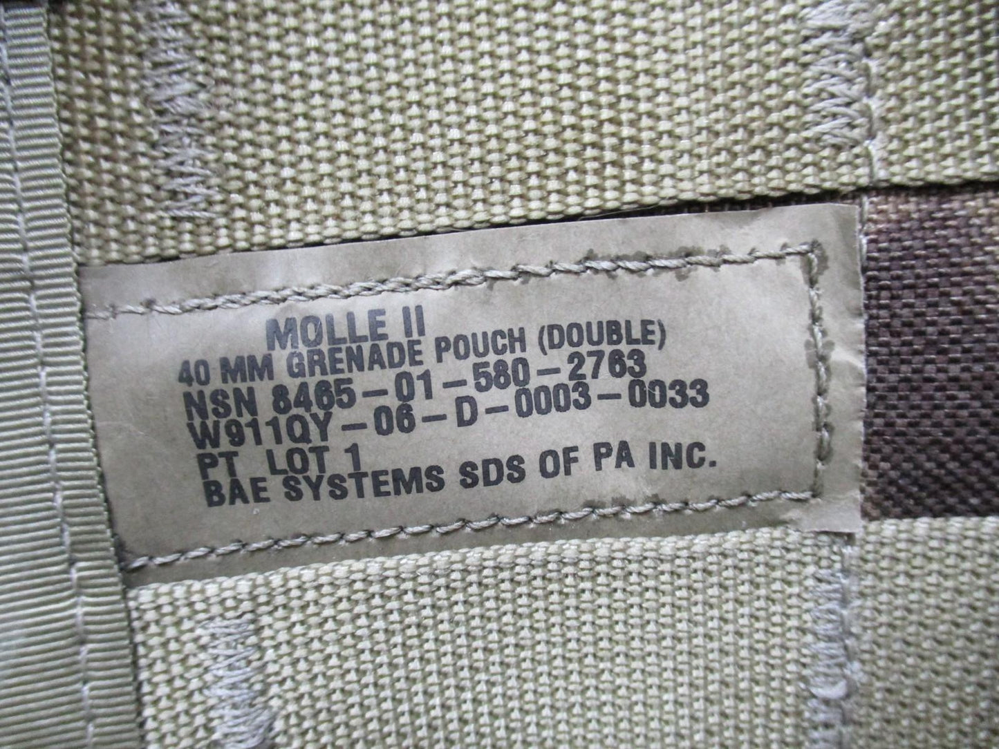 USGI MOLLE II 40mm grenade pouch set in Multicam with one double and two single pouches, designed for military gear.