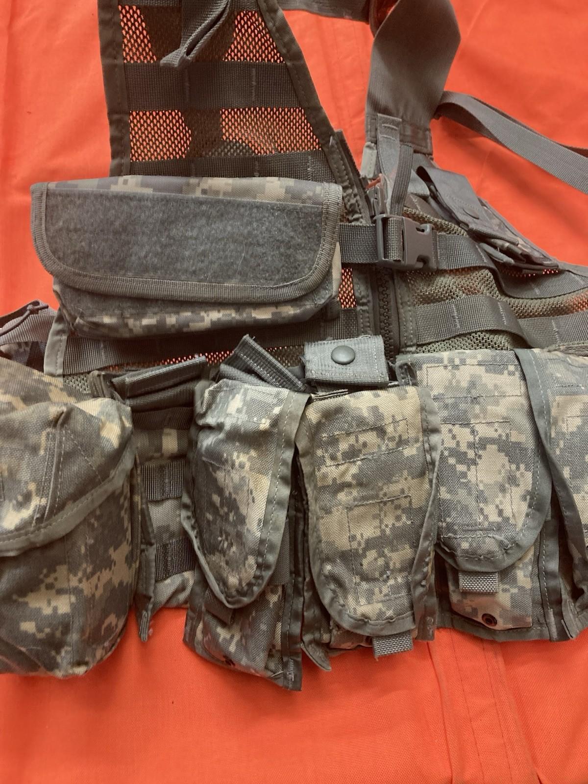 Army issue Riflemen set with ACU FLC vest, tactical MOLLE gear, and military camouflage for combat-ready appearance.