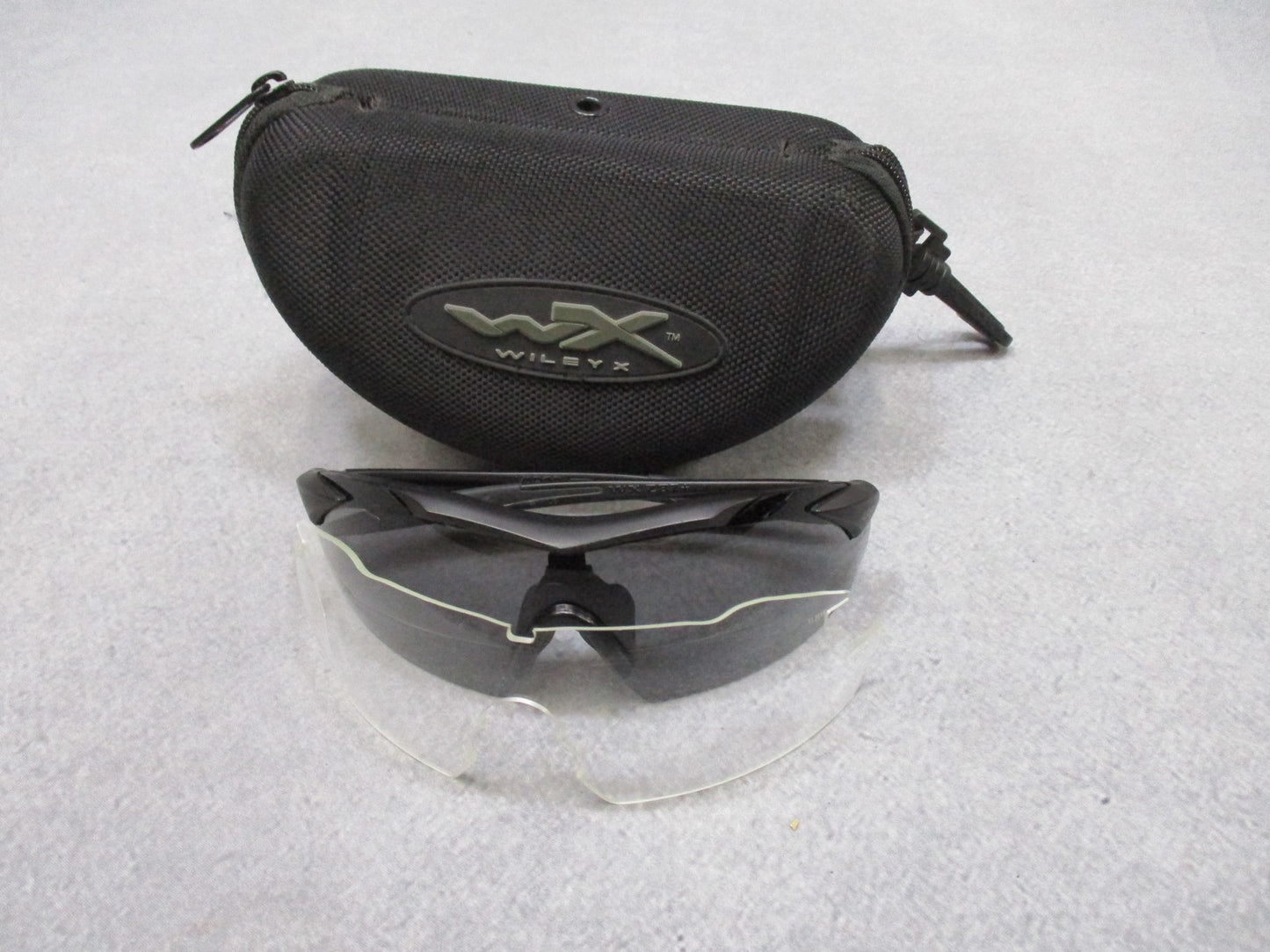Wiley X Vapor sunglasses with interchangeable lenses and case, featuring wraparound design and black frame, used condition.