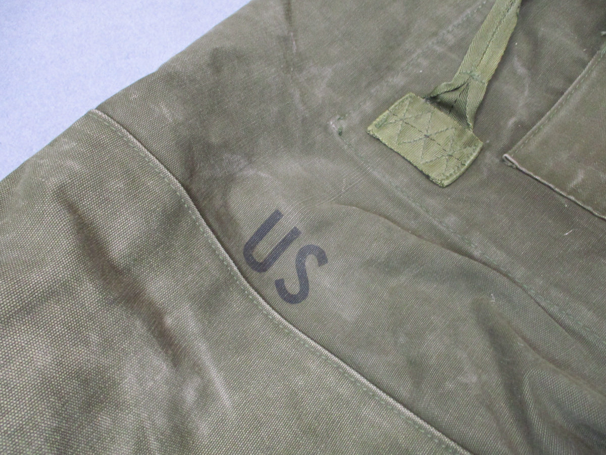 USGI 1980s OD green cotton canvas duffel sea bag with military surplus used condition, featuring sturdy handles and vintage design.