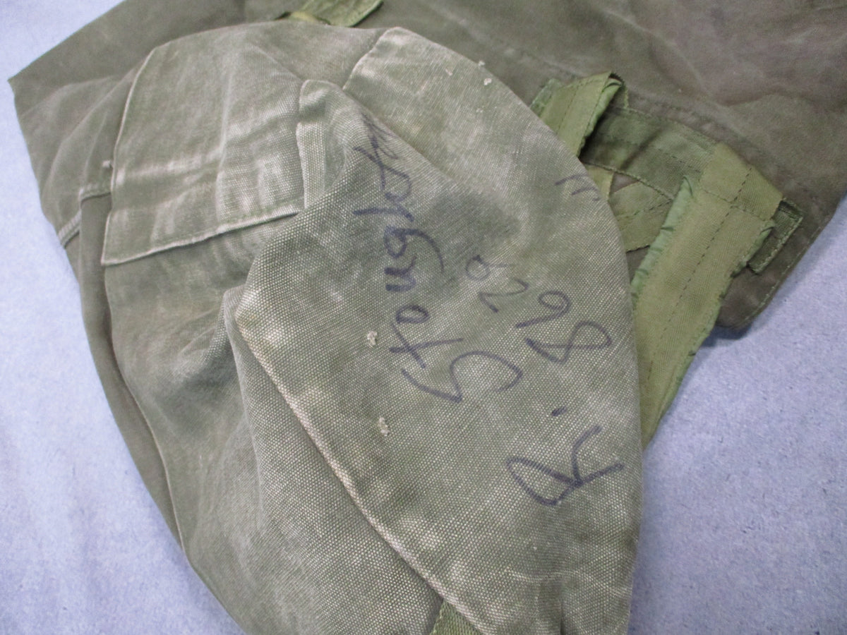 USGI 1980s OD green cotton canvas duffel sea bag with military surplus details, used condition and sturdy design.