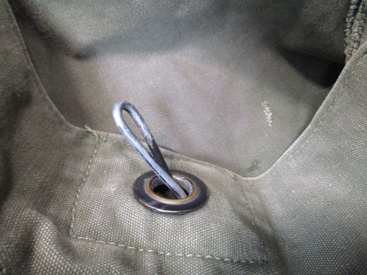 Used USGI 1980s OD green cotton canvas duffel sea bag with military surplus style and sturdy construction.