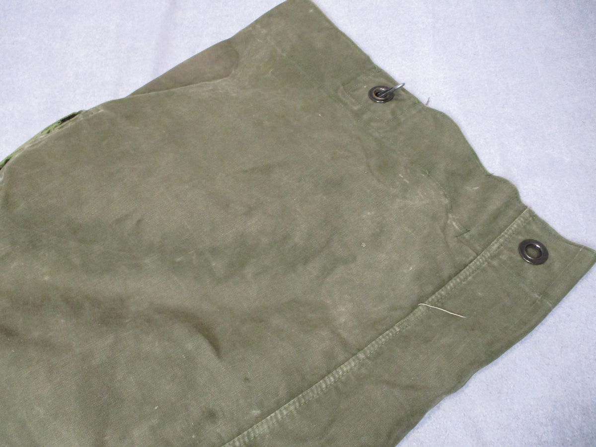 Used USGI 1980s OD green cotton canvas duffel sea bag with military surplus design, rugged and functional for travel or storage.