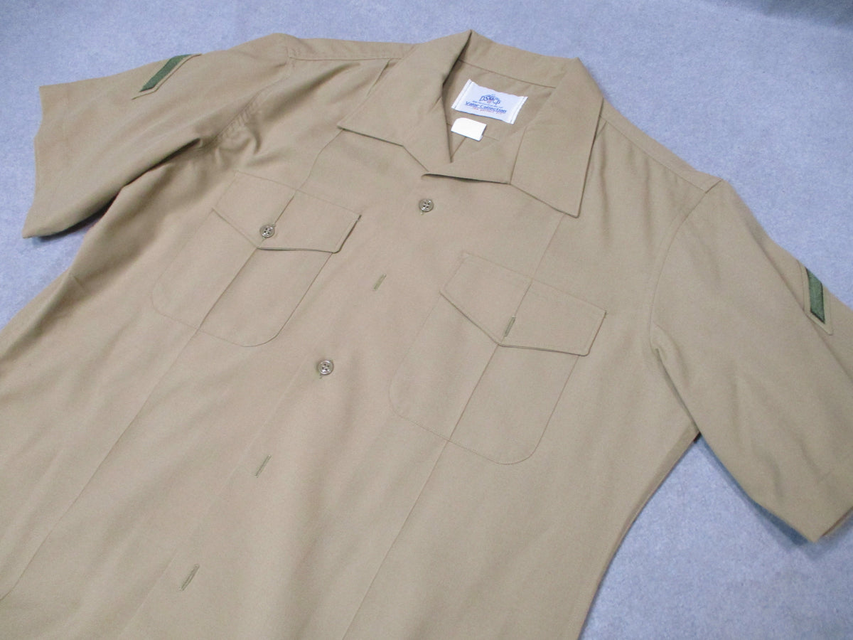 Genuine USMC Woolrich Valor khaki dress shirt, short sleeve, size 16.5, with military style fabric and button front detail.