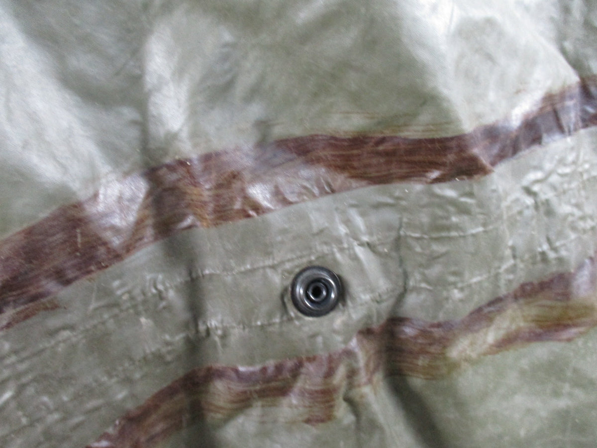 German Bundeswehr military poncho in OD green, used rain cape with shelter features, shown laid flat.