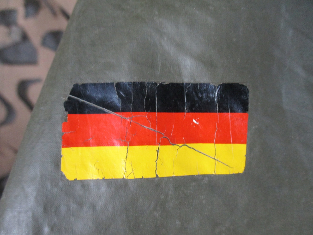 German Bundeswehr military OD green rain poncho with hood, used, lightweight rain cape for shelter and outdoor protection.
