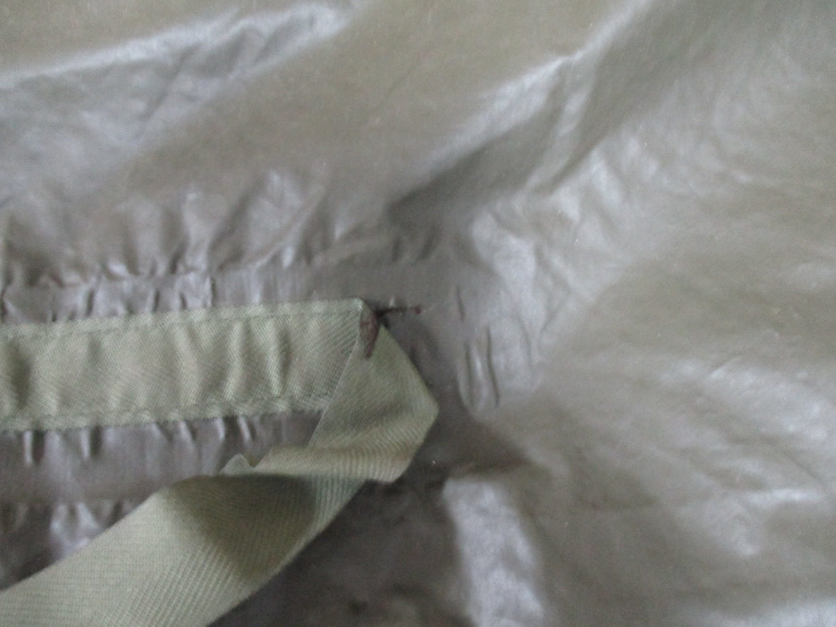 Used German Bundeswehr military OD green rain poncho with hood, lightweight rain cape suitable for outdoor shelter and protection.