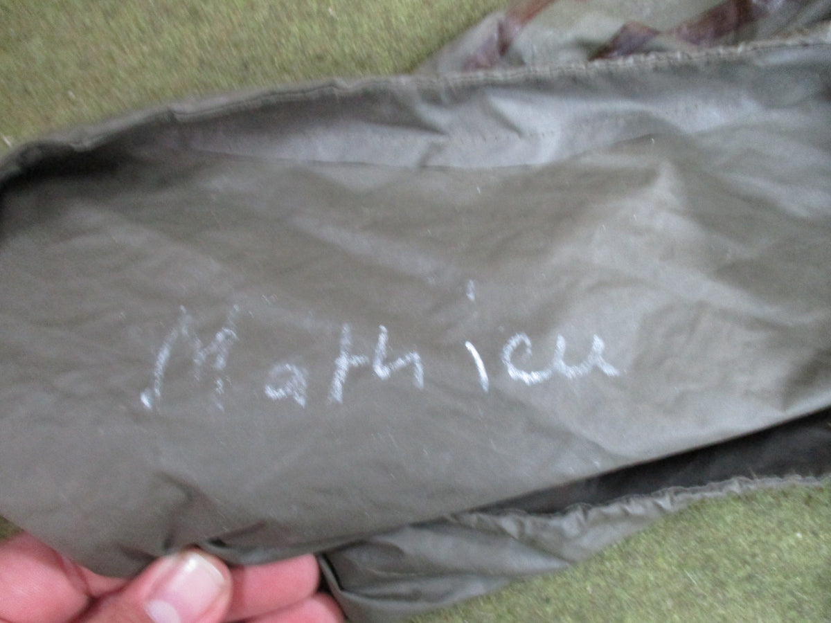 German Bundeswehr military poncho in olive green, used rain cape with shelter features, made by Bundeswehr.