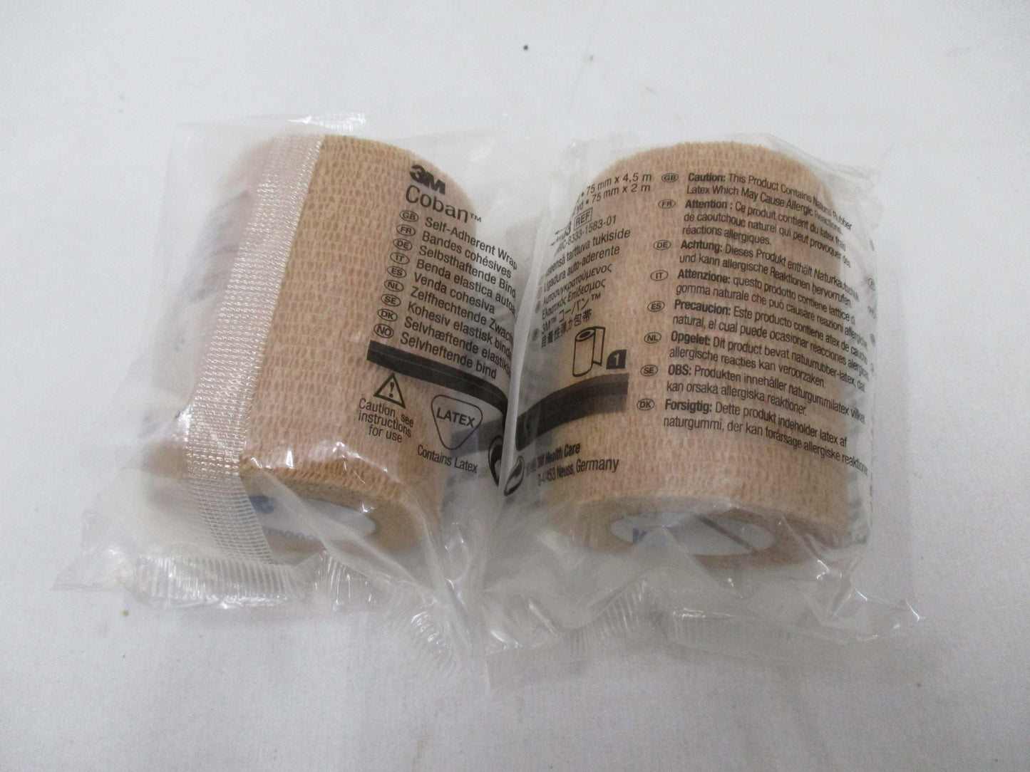 Two rolls of 3M Coban self-adherent wrap in tan, 3 inches by 5 yards, by Centex Military Gear, displayed side by side.