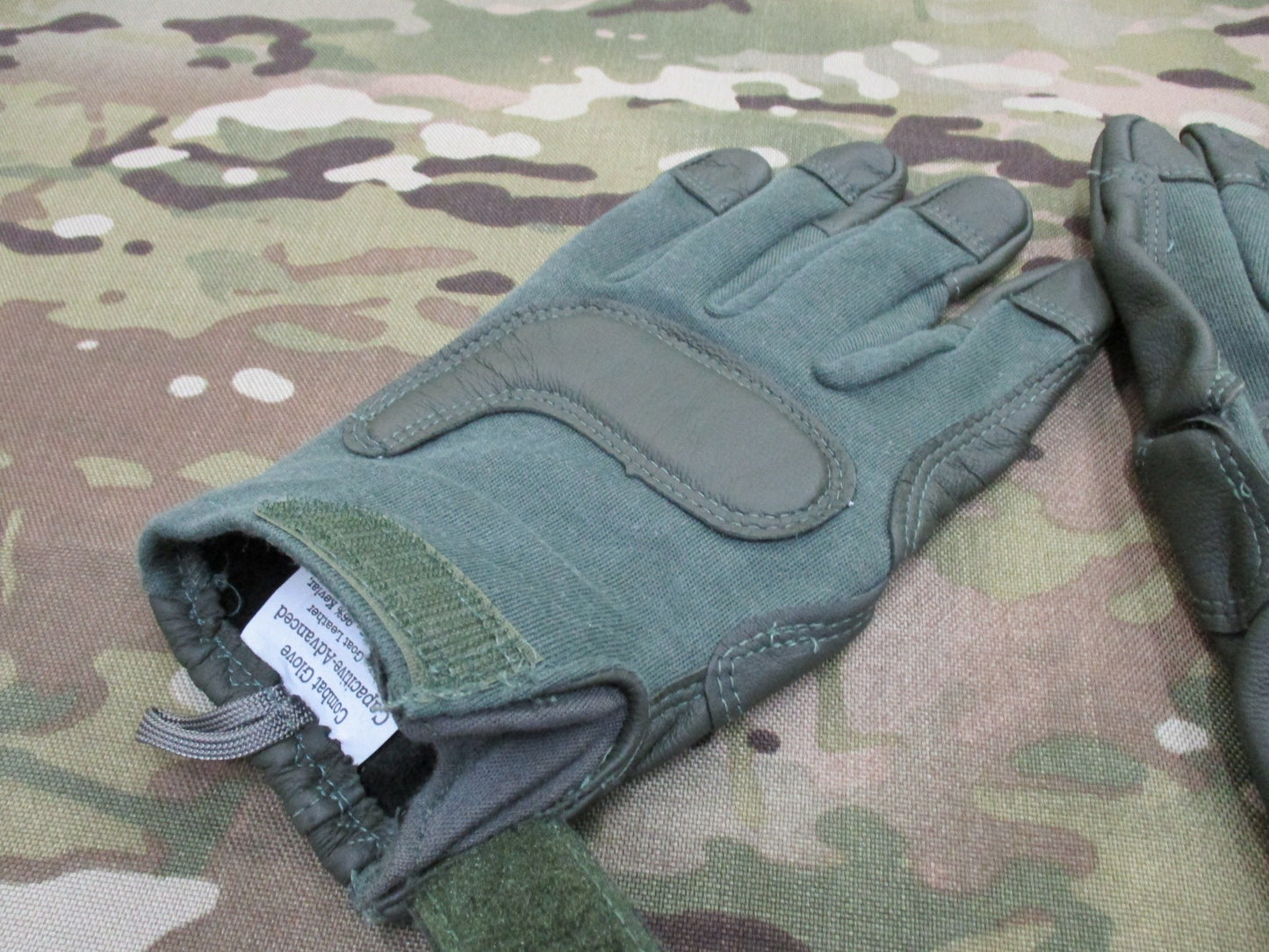 Sage green US Army combat gloves by Hatch HWI, cut and fire resistant, size X-large, displayed on a neutral background.