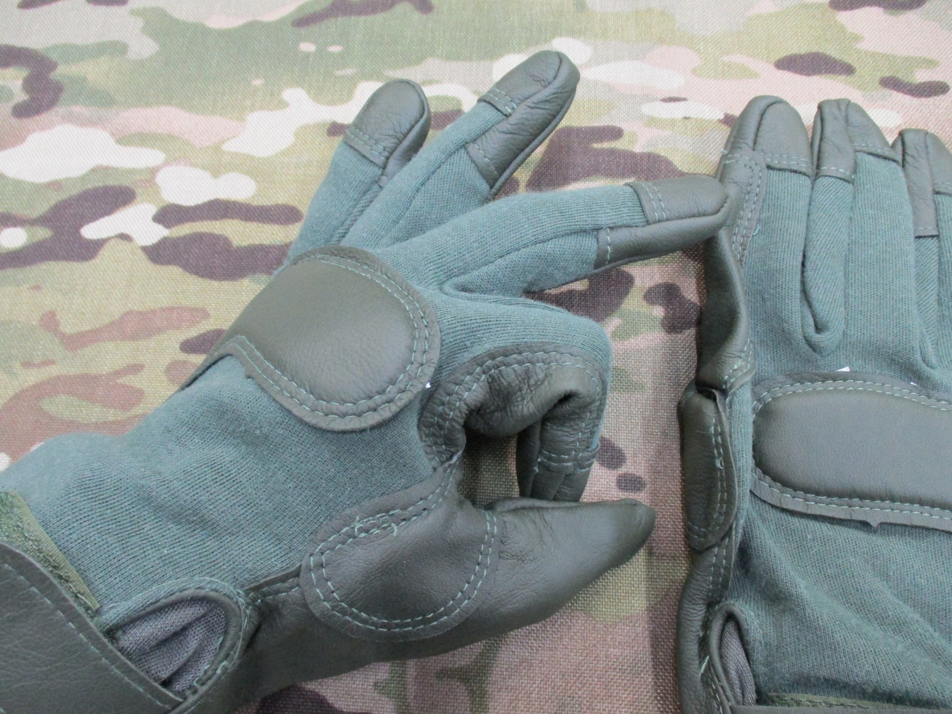 Sage green US Army combat gloves, cut and fire resistant, X-large size by Hatch HWI, displayed on a neutral background.