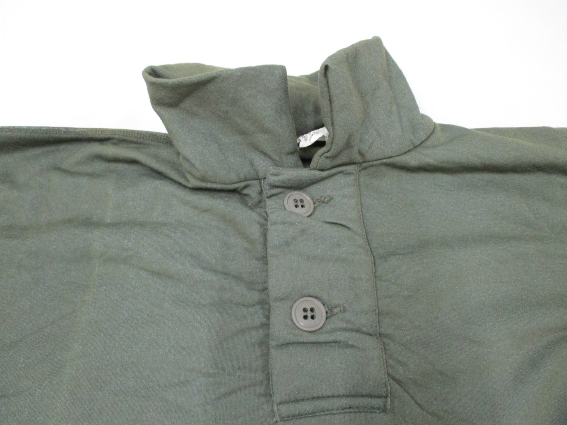 Vintage USGI Vietnam 1969 olive drab tricot knit shirt in small size, featuring a sleeping man's OG 106 design.