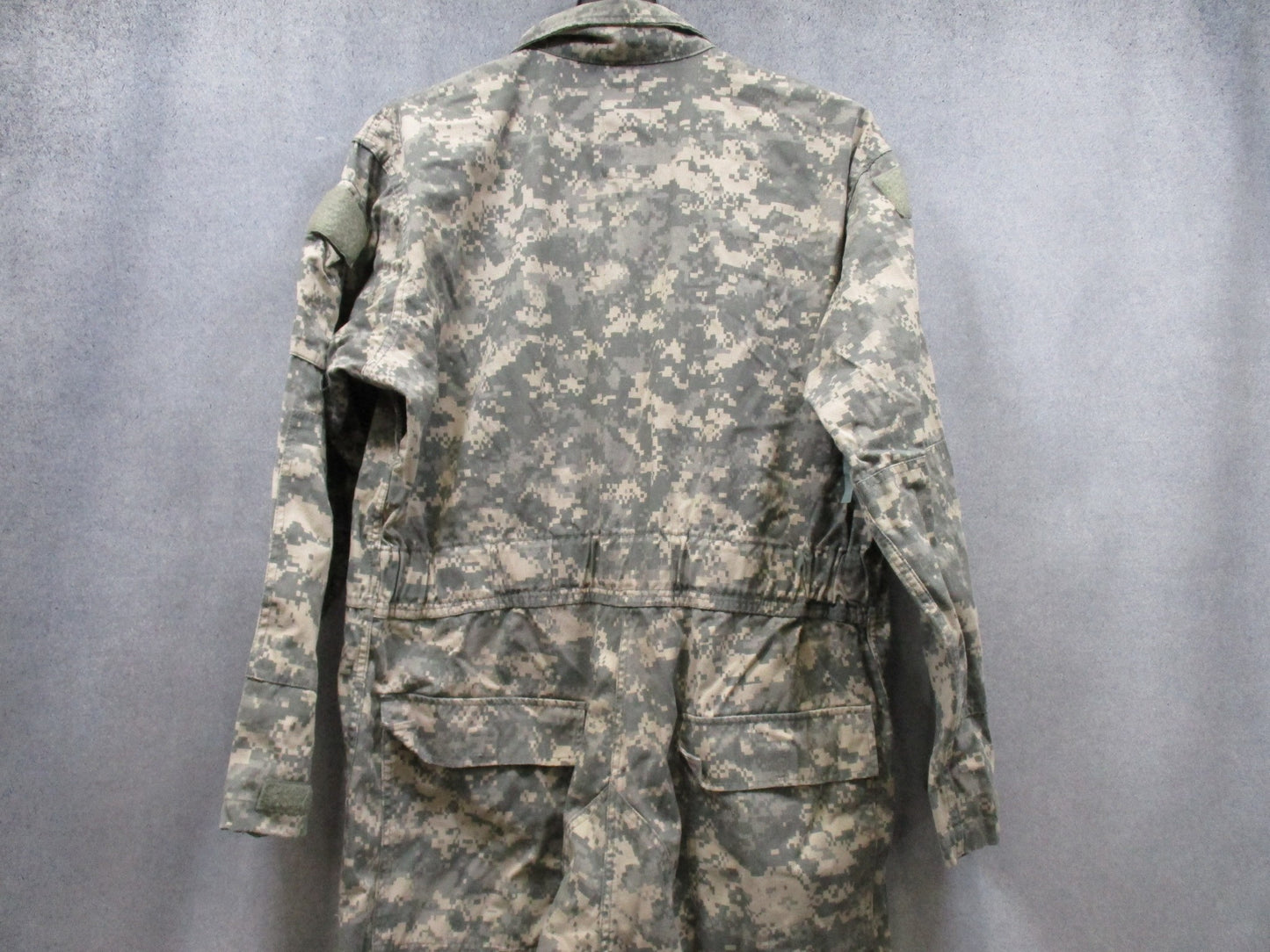 US Army Issue mechanic coveralls in UCP ACU digital camo, size X-Large, by Centex Military Gear, displayed on a hanger.