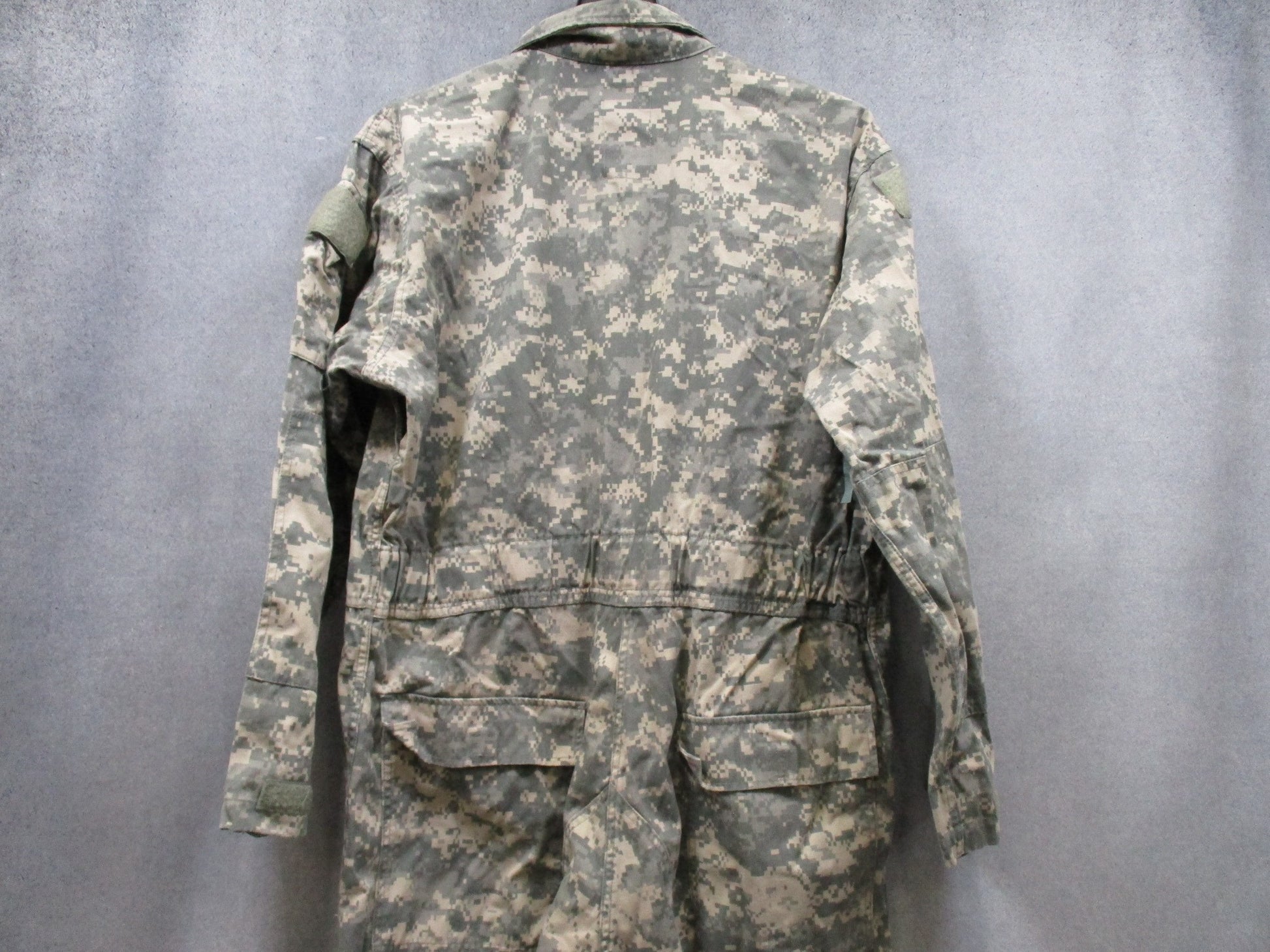 US Army Issue mechanic coveralls in UCP ACU digital camo, size X-Large, by Centex Military Gear, displayed on a hanger.
