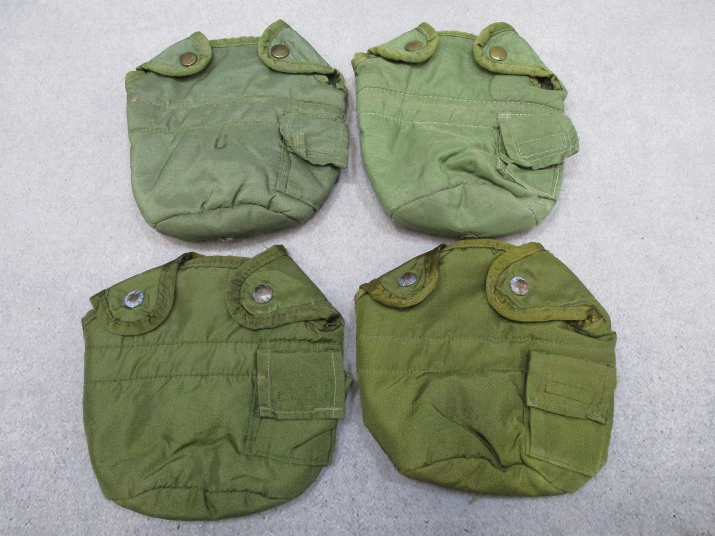 Four OD Green insulated military canteen covers with LC-2 ALICE clips by Centex Military Gear.