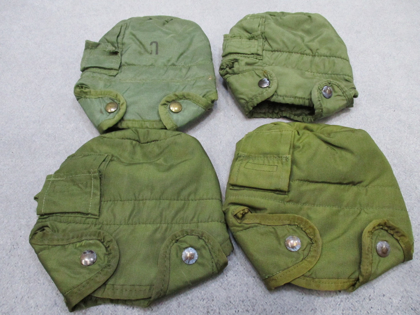 Four insulated OD green military canteen covers with LC-2 ALICE clips by Centex Military Gear.