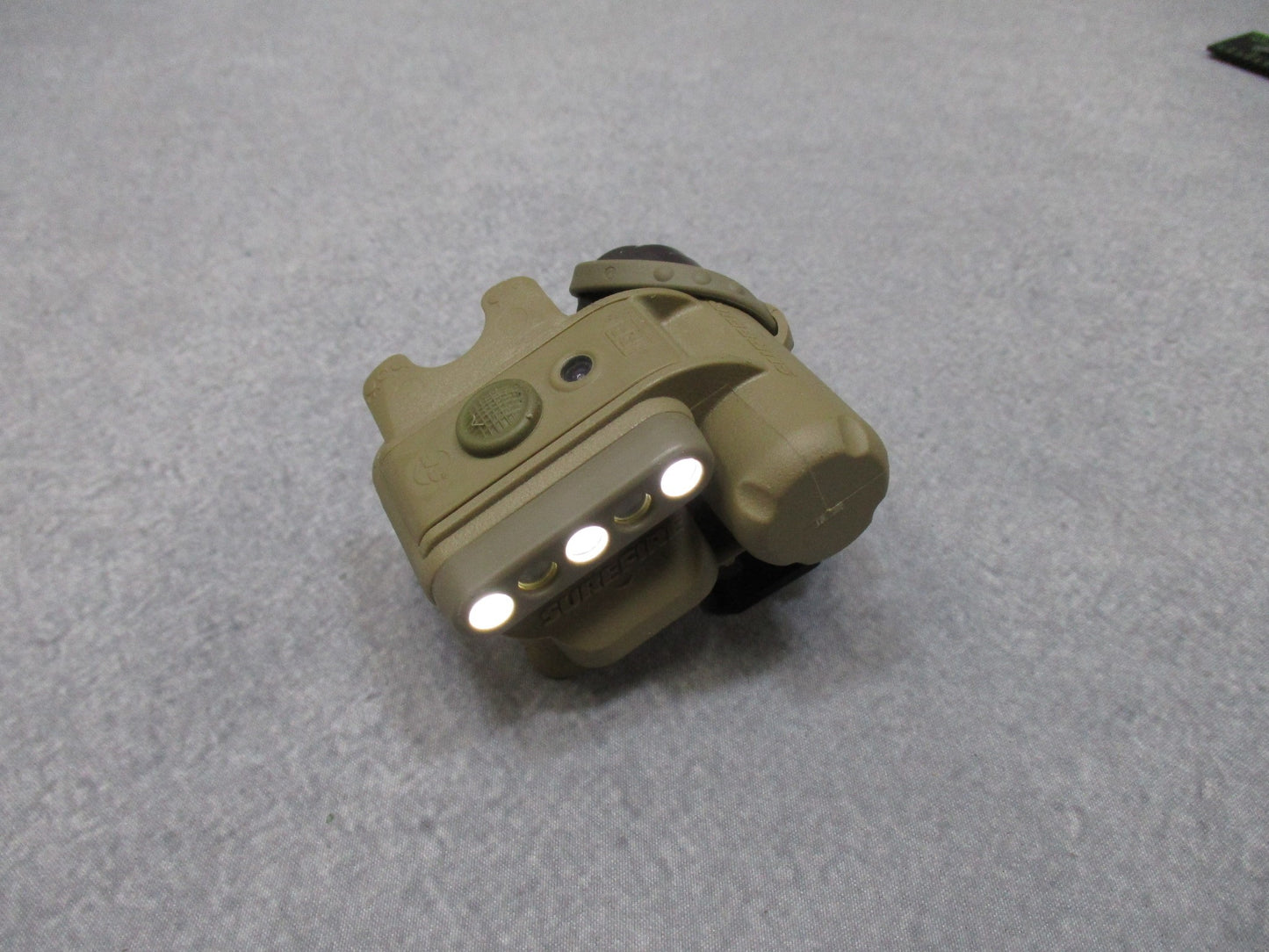 Centex Military Gear Army tan SureFire helmet light with white/blue LEDs, IR strobe, mounted on ACH/MICH helmet for tactical use.