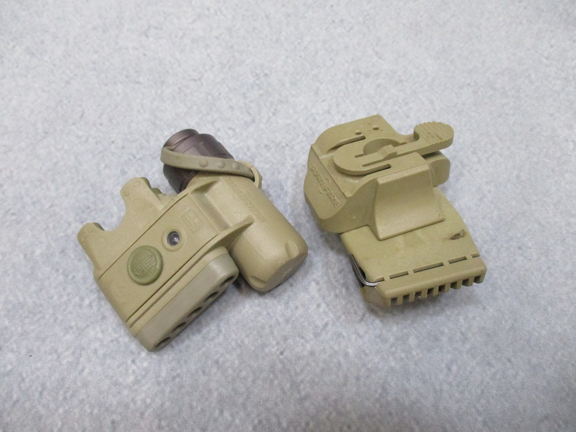 SureFire helmet light in army tan with white and blue LEDs, IR strobe, mounted on ACH/MICH helmet, used by military personnel