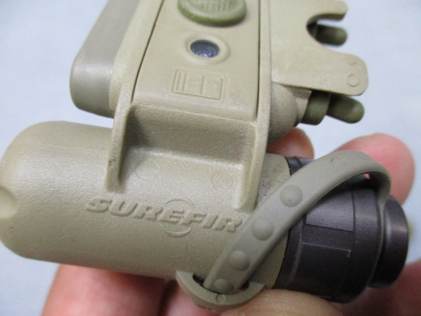 Army tan SureFire helmet light with white and blue LEDs, IR strobe, mounted on ACH/MICH helmet by Centex Military Gear.