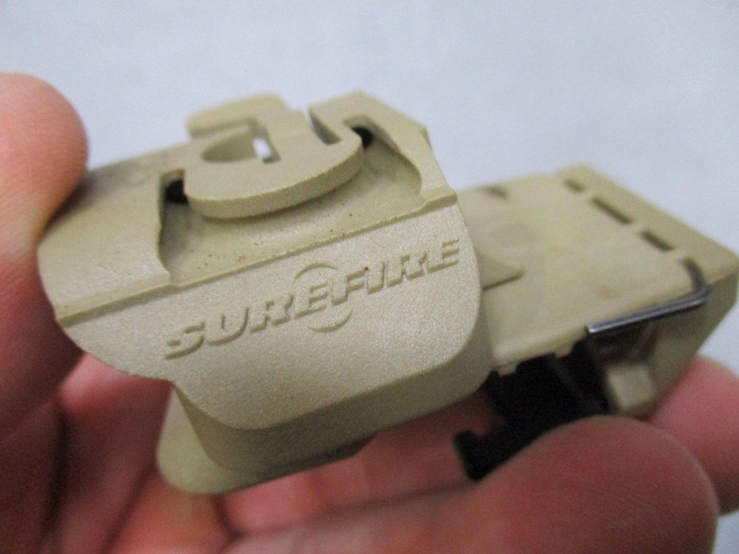 Army tan SureFire helmet light with white/blue LEDs, IR strobe, mounted on MICH helmet used by Centex Military Gear.