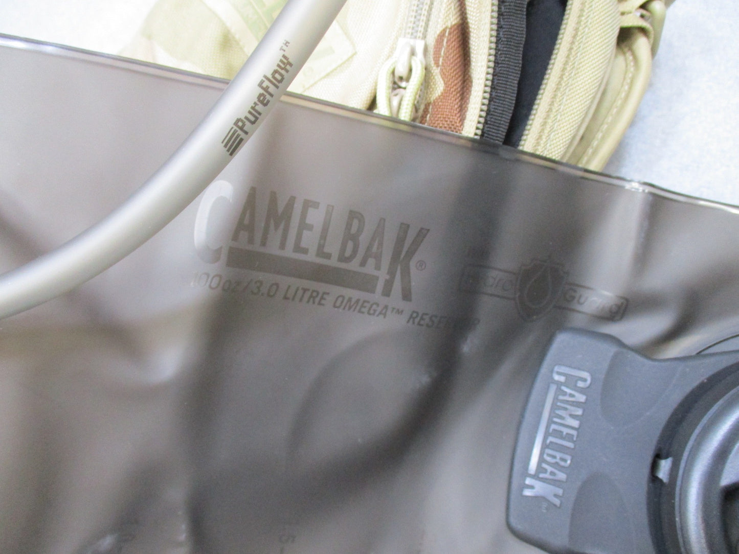 CamelBak MULE hydration pack in desert tan with tactical design, featuring a spacious backpack and hydration carrier.