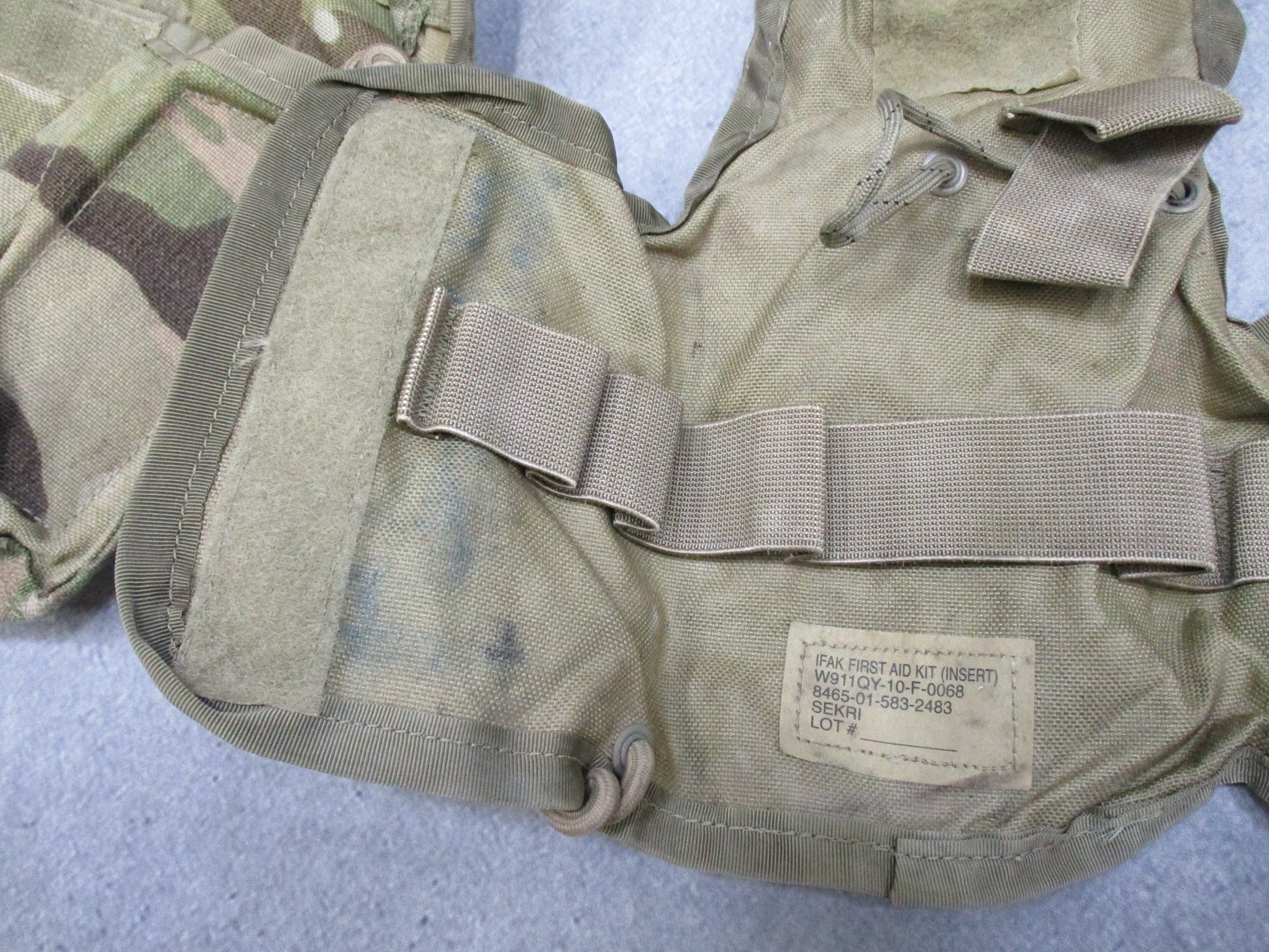 USGI Multicam IFAK pouch with expired medical contents, military first aid kit, by Centex Military Gear, shown with medical supplies inside.