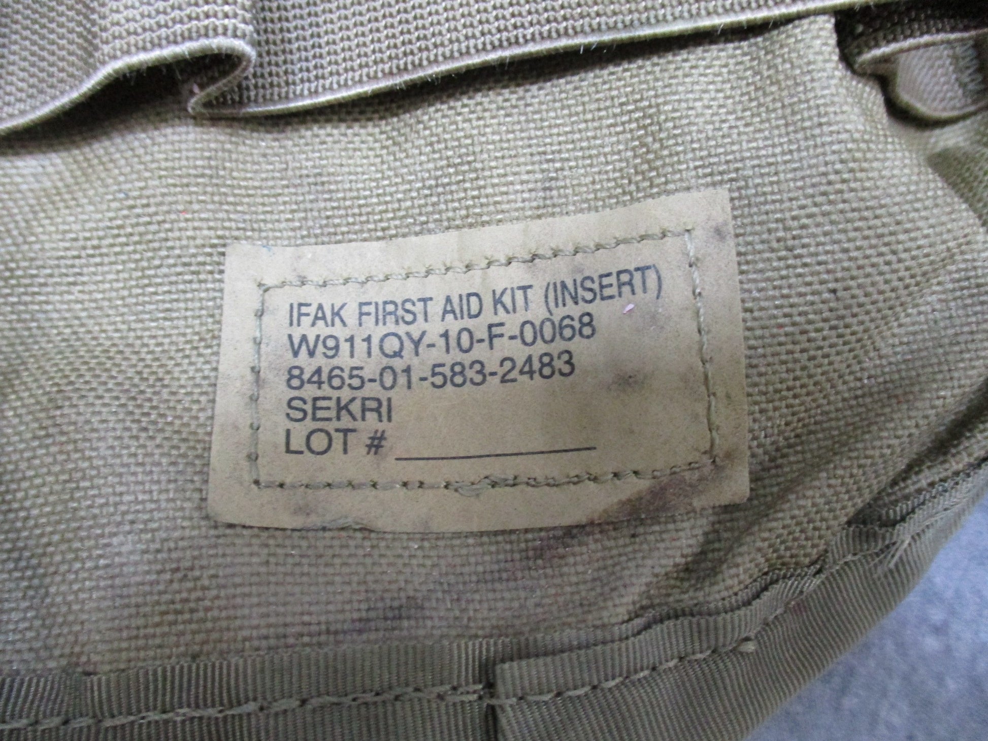 USGI Multicam IFAK pouch by Centex Military Gear with expired medical supplies, military-style first aid kit for tactical use.