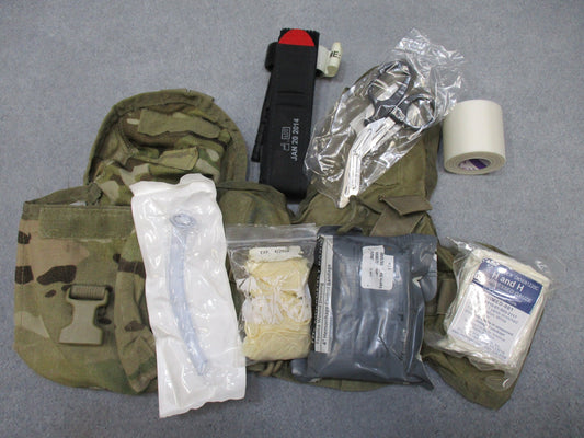 USGI Multicam IFAK pouch with expired medical supplies, military first aid kit by Centex Military Gear, designed for tactical use.
