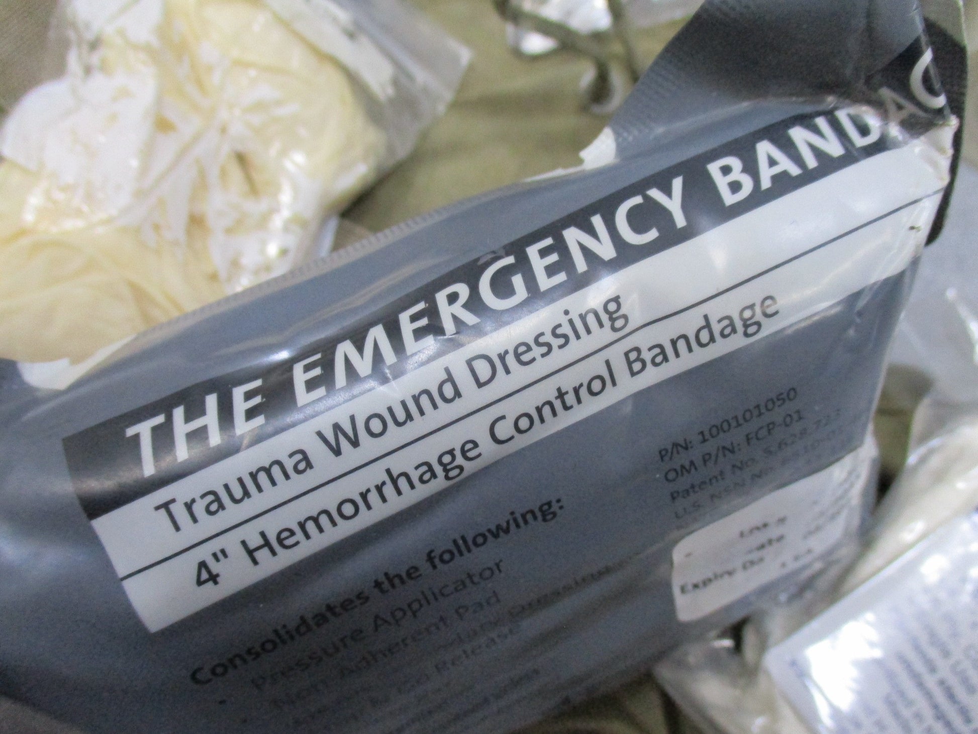 USGI Multicam IFAK pouch with expired medical supplies, military first aid kit by Centex Military Gear, shown with open pouch and contents