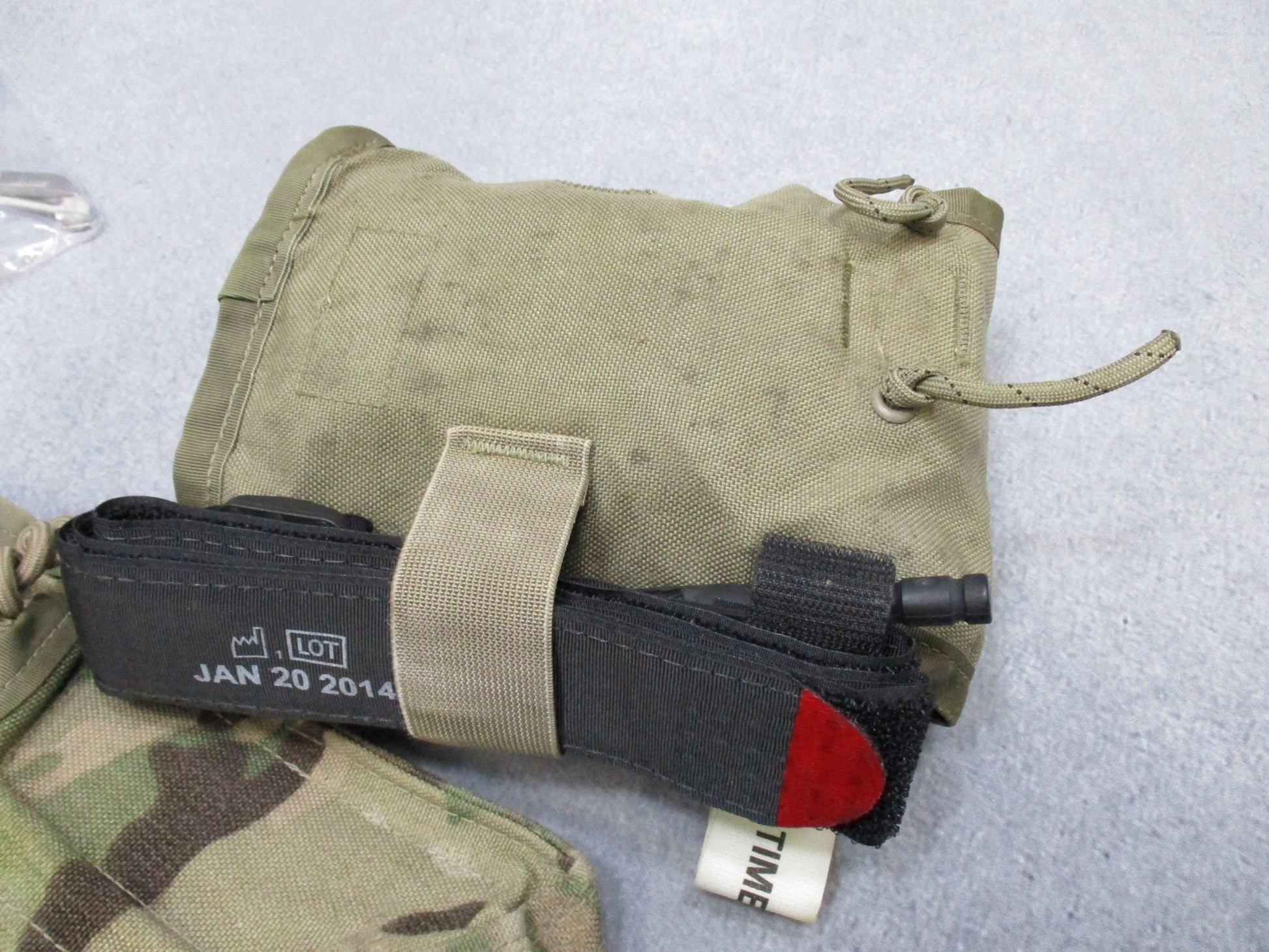 USGI Multicam IFAK pouch with expired medical supplies, military first aid kit by Centex Military Gear, ready for emergency use